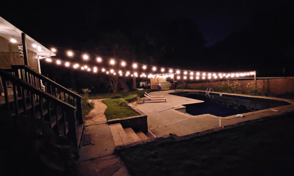 A project by Handyman Atlanta hanging outdoor lights in a backyard.