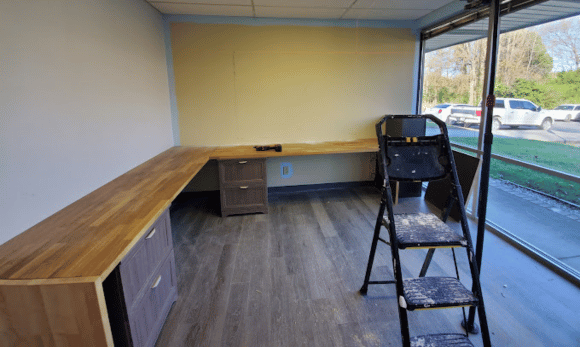 A project by Handyman Atlanta building shelves in an office setting.